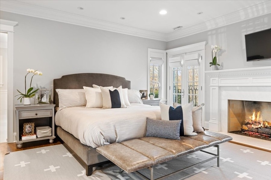 1045 Starr Road Winnetka, IL 60093 - Photo 21 of 57 a bedroom with a bed a flat screen tv and fireplace