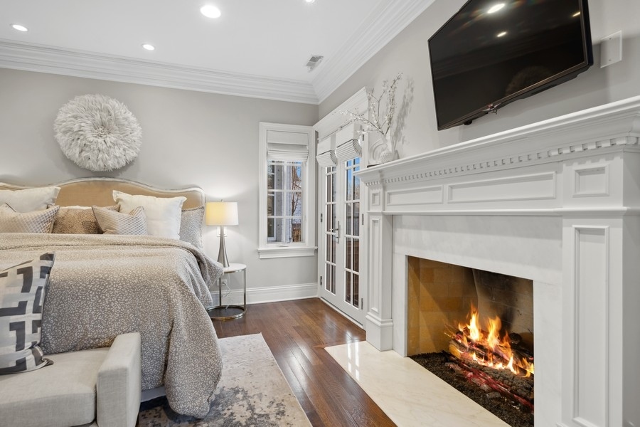 1045 Starr Road Winnetka, IL 60093 - Photo 22 of 57 a bedroom with a bed and a fireplace