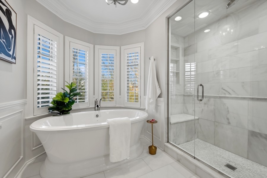 1045 Starr Road Winnetka, IL 60093 - Photo 27 of 57 a white bath tub sitting in a spacious bathroom next to a window