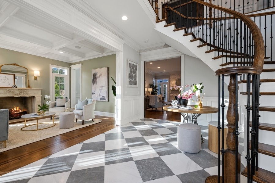 1045 Starr Road Winnetka, IL 60093 - Photo 3 of 57 a living room with furniture a fireplace and a chandelier