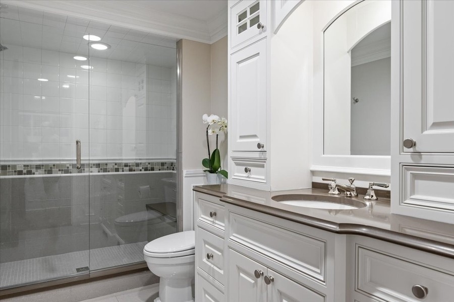 1045 Starr Road Winnetka, IL 60093 - Photo 47 of 57 a bathroom with a sink a toilet and shower