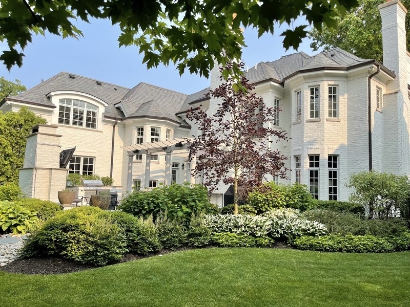 1045 Starr Road Winnetka, IL 60093 - Photo 48 of 57 a front view of a white house with a yard