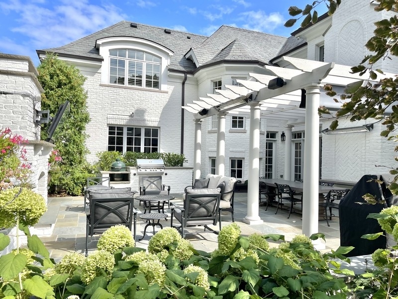 1045 Starr Road Winnetka, IL 60093 - Photo 49 of 57 a view of a patio with table and chairs potted plants and a large tree