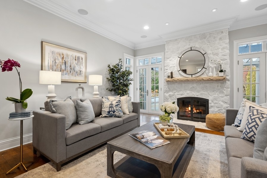 1045 Starr Road Winnetka, IL 60093 - Photo 7 of 57 a living room with furniture a fireplace and a large mirror