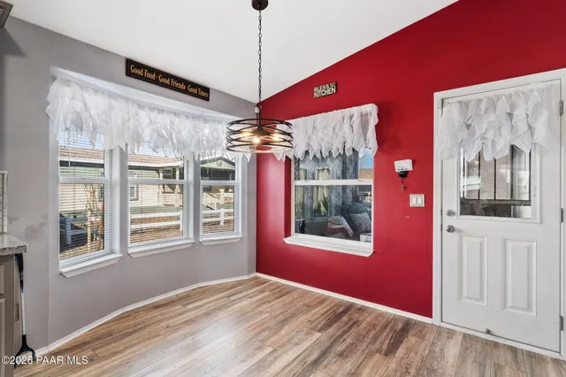 a view of a livingroom with a window and wooden floor