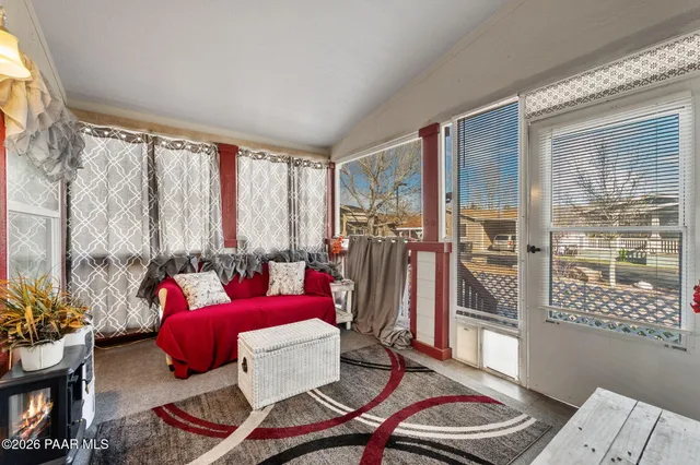 a living room with furniture and a floor to ceiling window