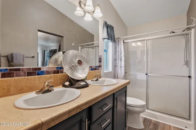 a bathroom with a toilet a sink and a mirror