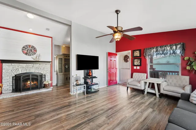 a living room with furniture a flat screen tv and a fireplace