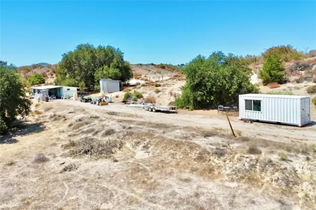 a backyard of a house with large trees and outdoor space