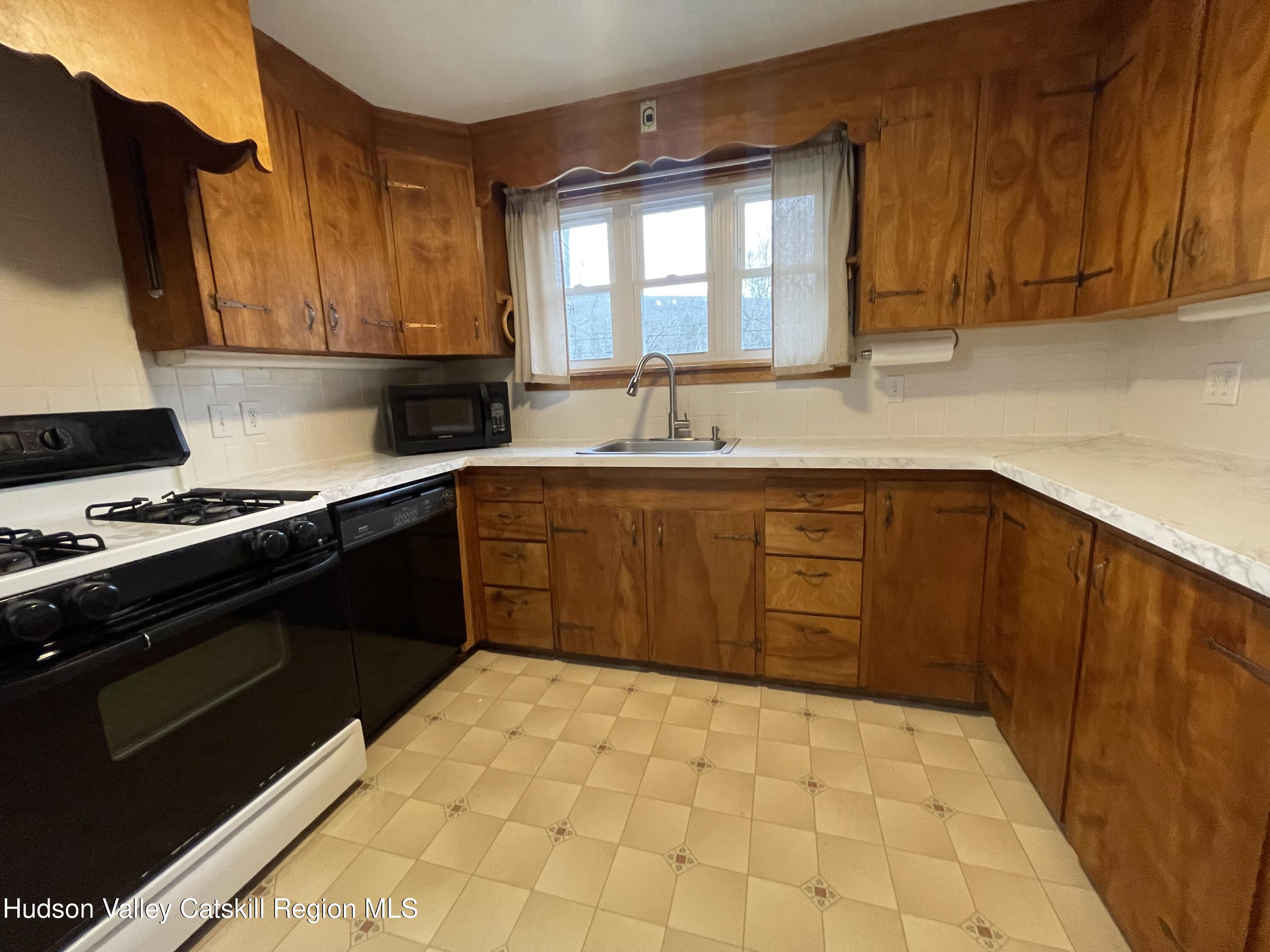 265 Scribner Hollow Road Hunter, NY 12442 - Photo 13 of 36 a kitchen with a sink a stove and cabinets