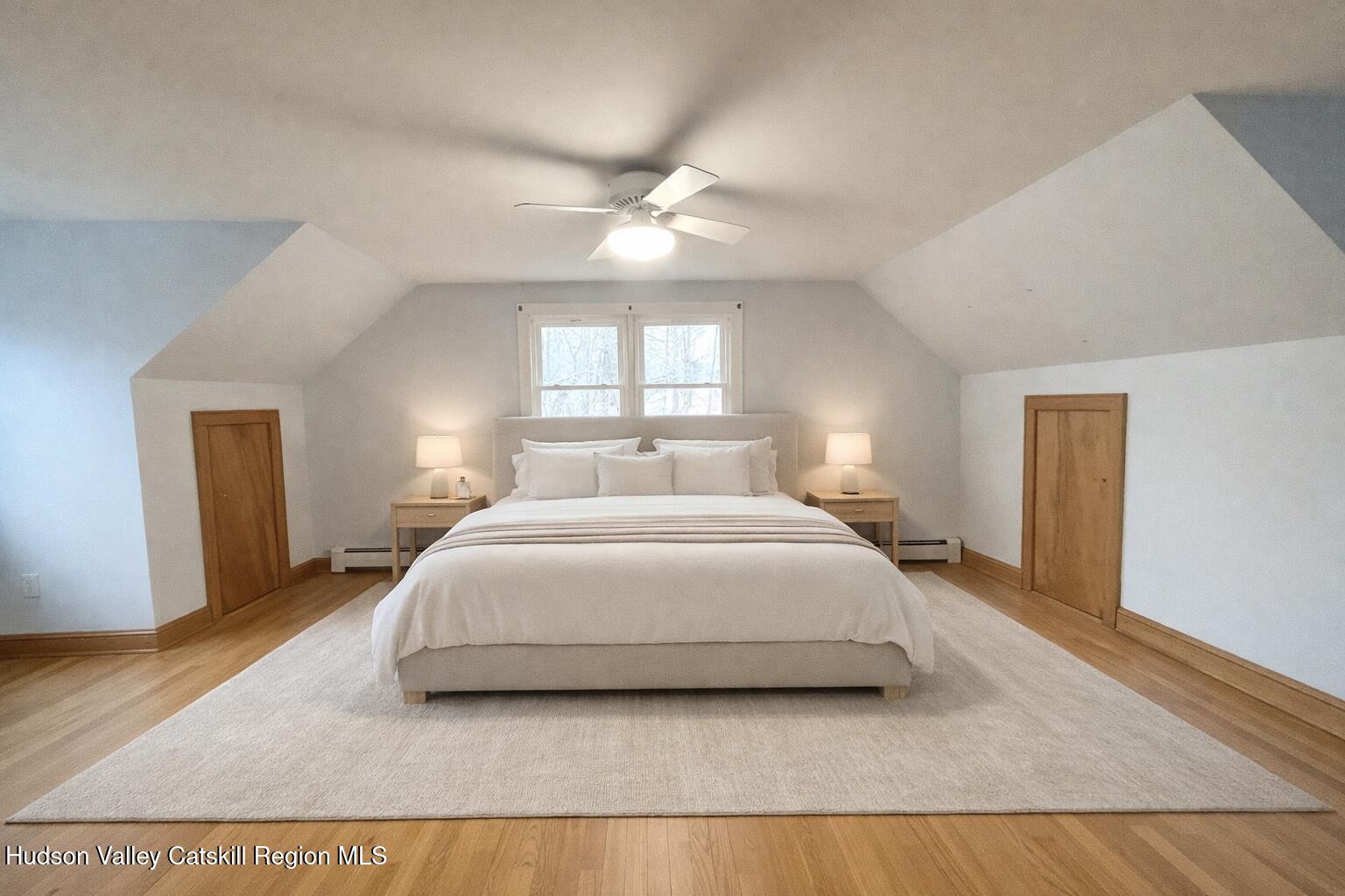 265 Scribner Hollow Road Hunter, NY 12442 - Photo 18 of 26 a bedroom with a large bed and a chandelier