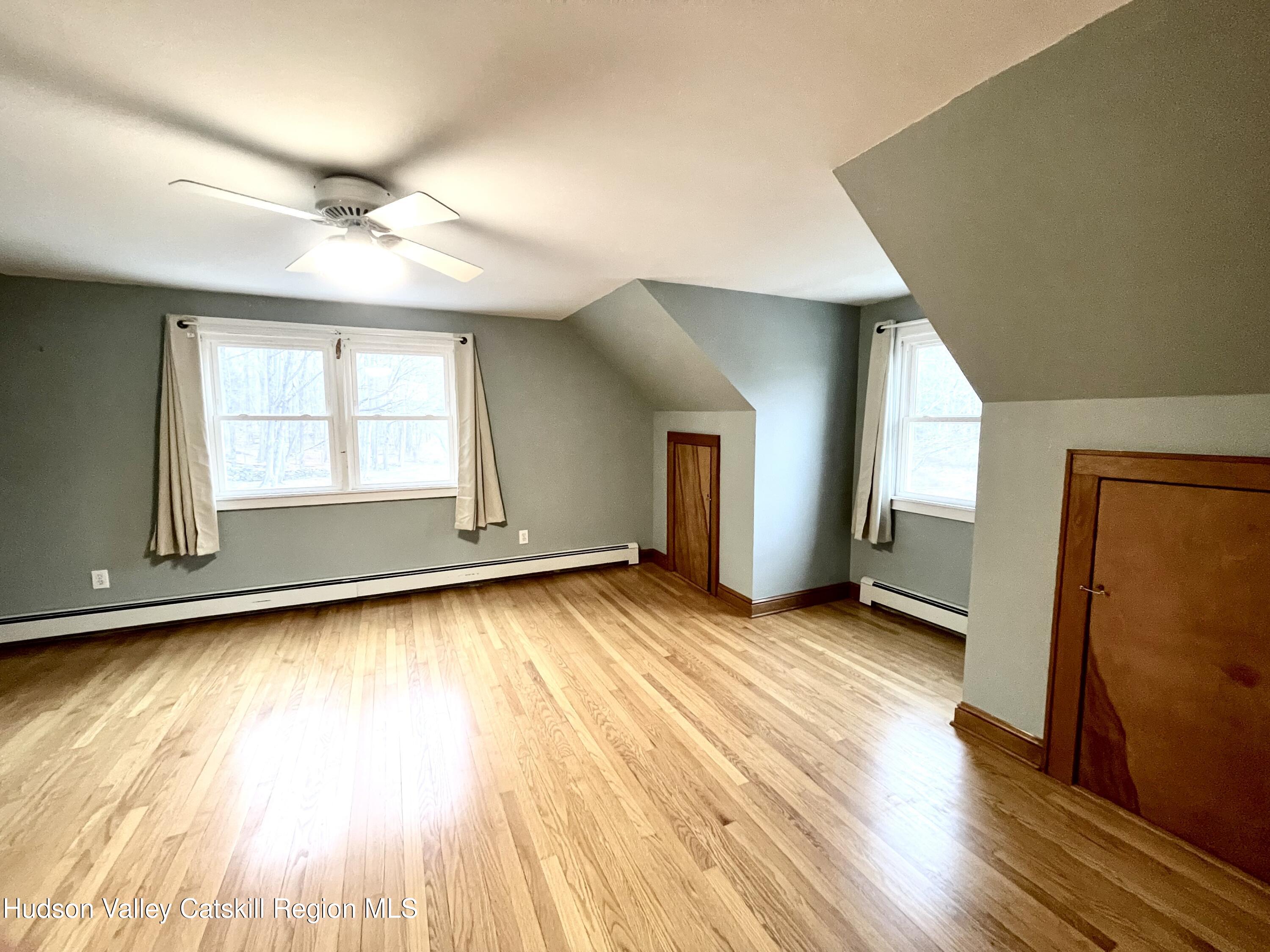 265 Scribner Hollow Road Hunter, NY 12442 - Photo 23 of 36 a view of an empty room with wooden floor and a window