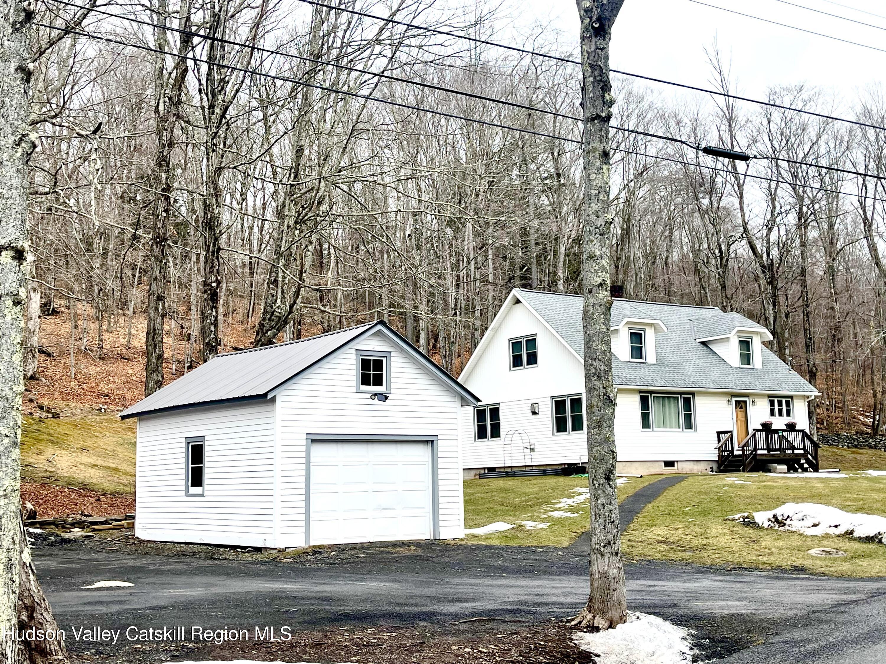 265 Scribner Hollow Road Hunter, NY 12442 - Photo 28 of 36 a view of a white house with a big yard plants and large tree