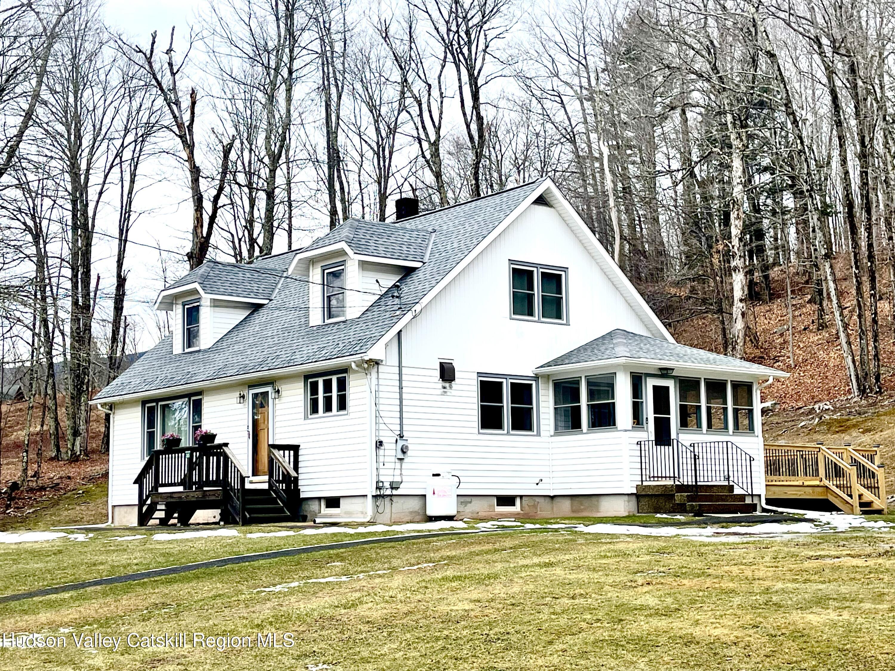 265 Scribner Hollow Road Hunter, NY 12442 - Photo 30 of 36 a front view of a house with a yard table and chairs
