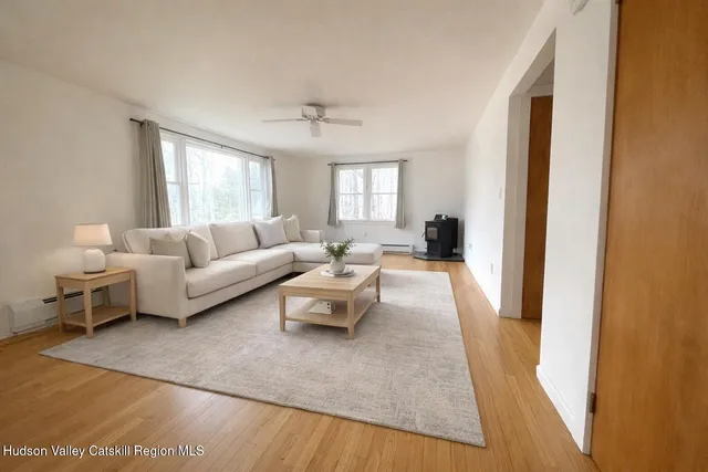 a kitchen with a table chairs refrigerator and window