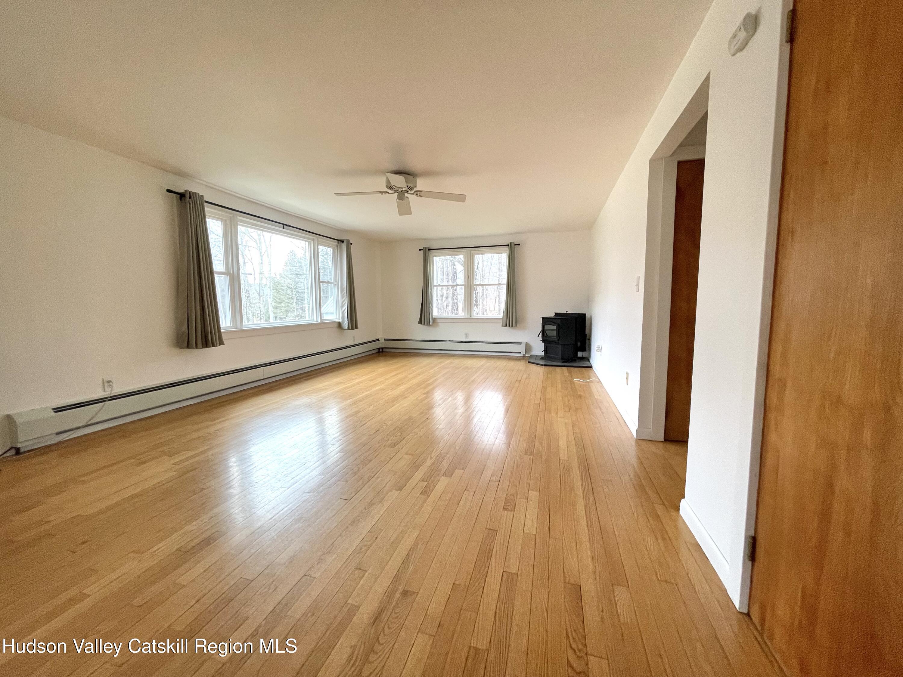 265 Scribner Hollow Road Hunter, NY 12442 - Photo 9 of 26 a view of a room with wooden floor and windows