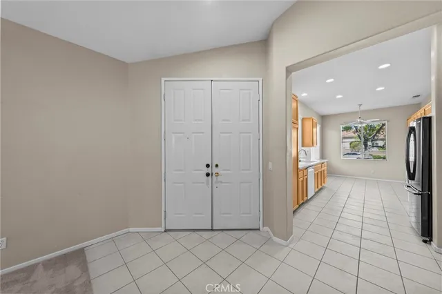 a view of a hallway to closet and a fireplace