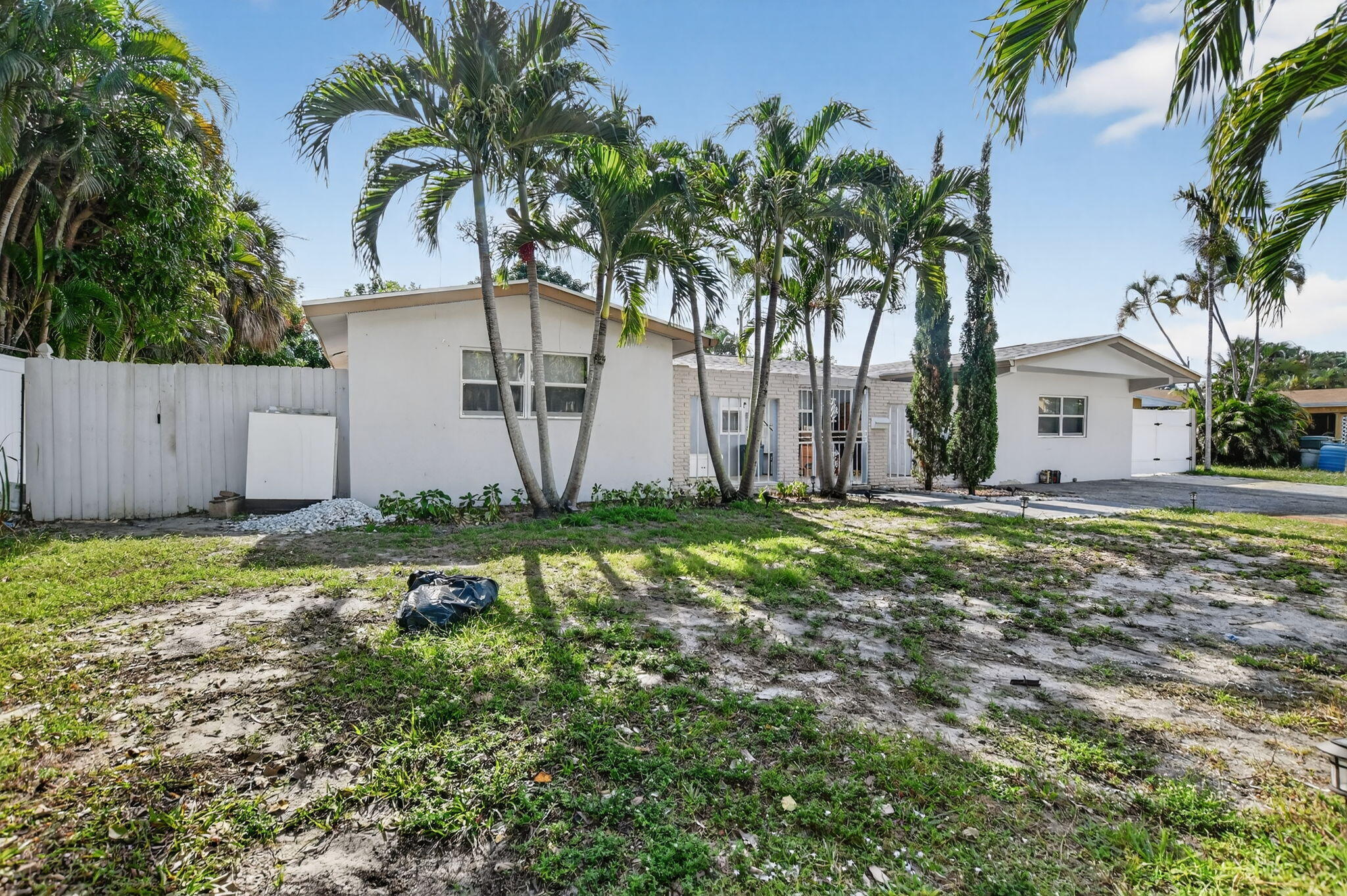 256 Southwest 11th Place Boca Raton, FL 33432 - Photo 1 of 43 a view of a backyard with potted plants and large trees