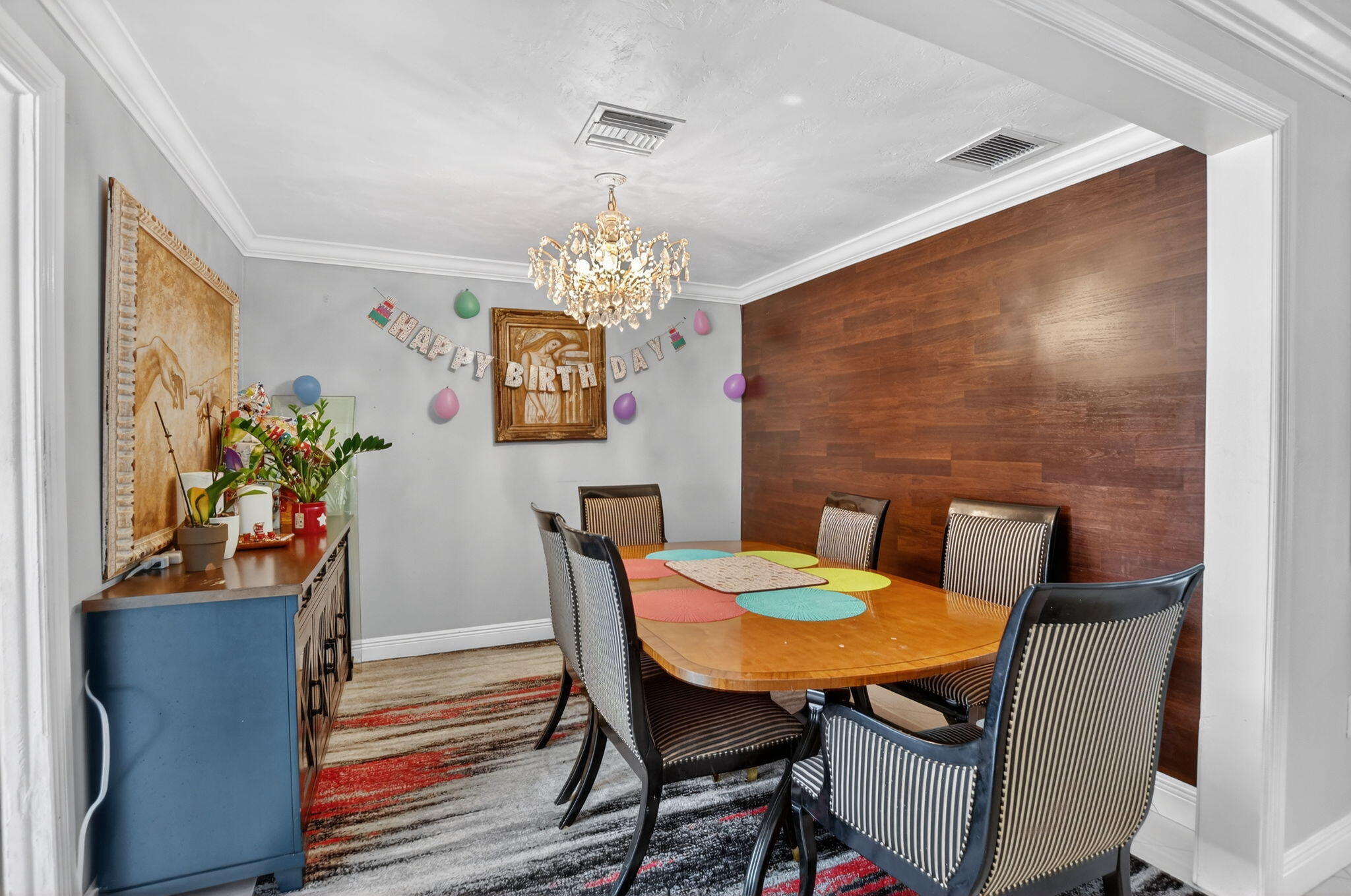 256 Southwest 11th Place Boca Raton, FL 33432 - Photo 13 of 43 a dining room with furniture potted plants and wooden floor
