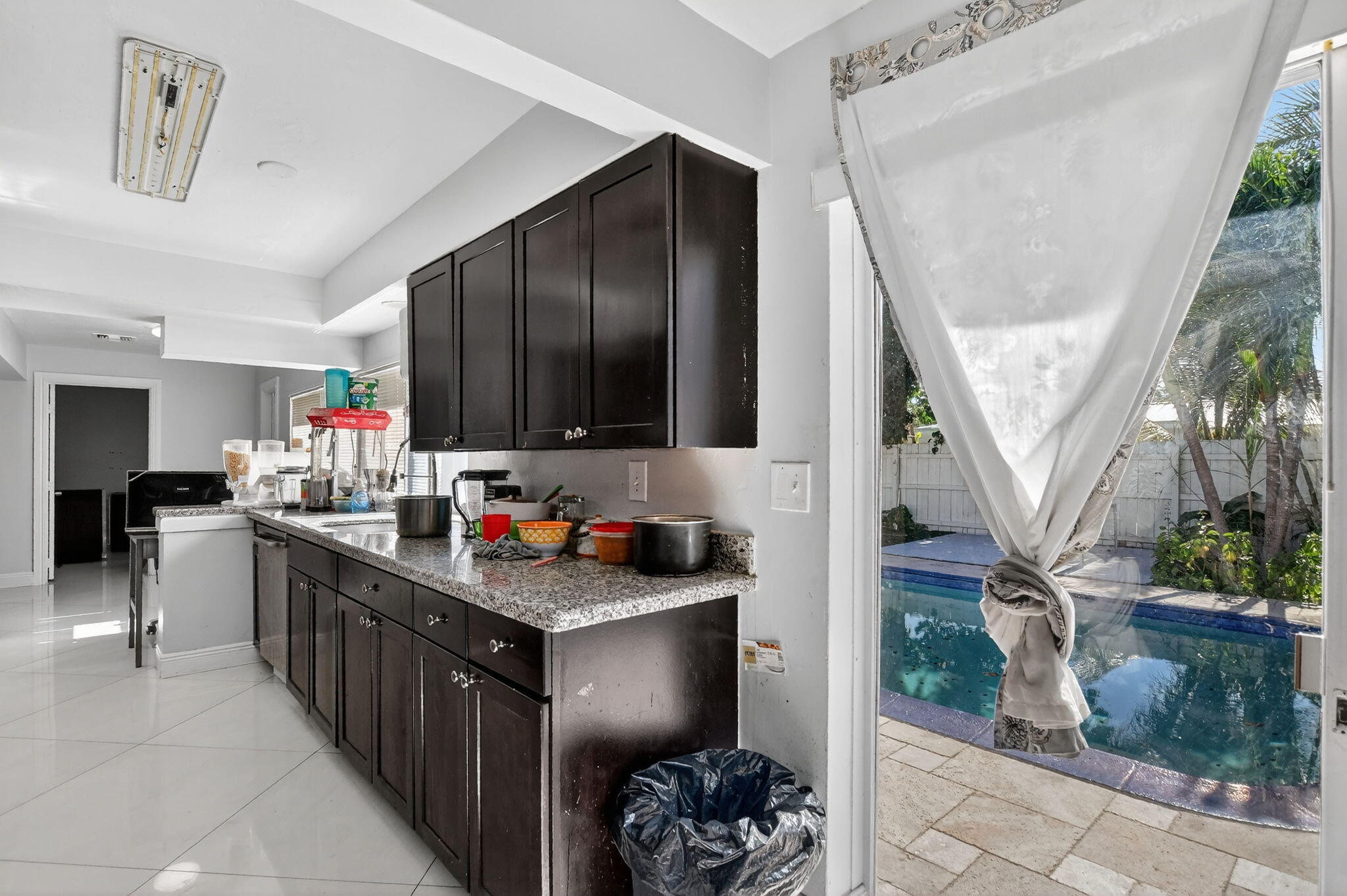 256 Southwest 11th Place Boca Raton, FL 33432 - Photo 20 of 43 a kitchen with sink cabinets and potted plant
