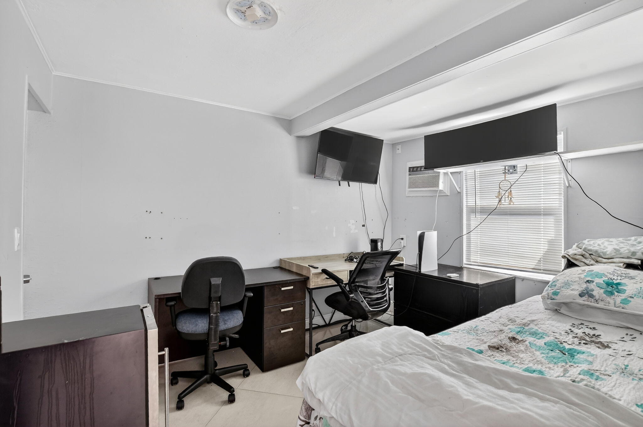 256 Southwest 11th Place Boca Raton, FL 33432 - Photo 23 of 43 a bedroom with a bed and wooden floor