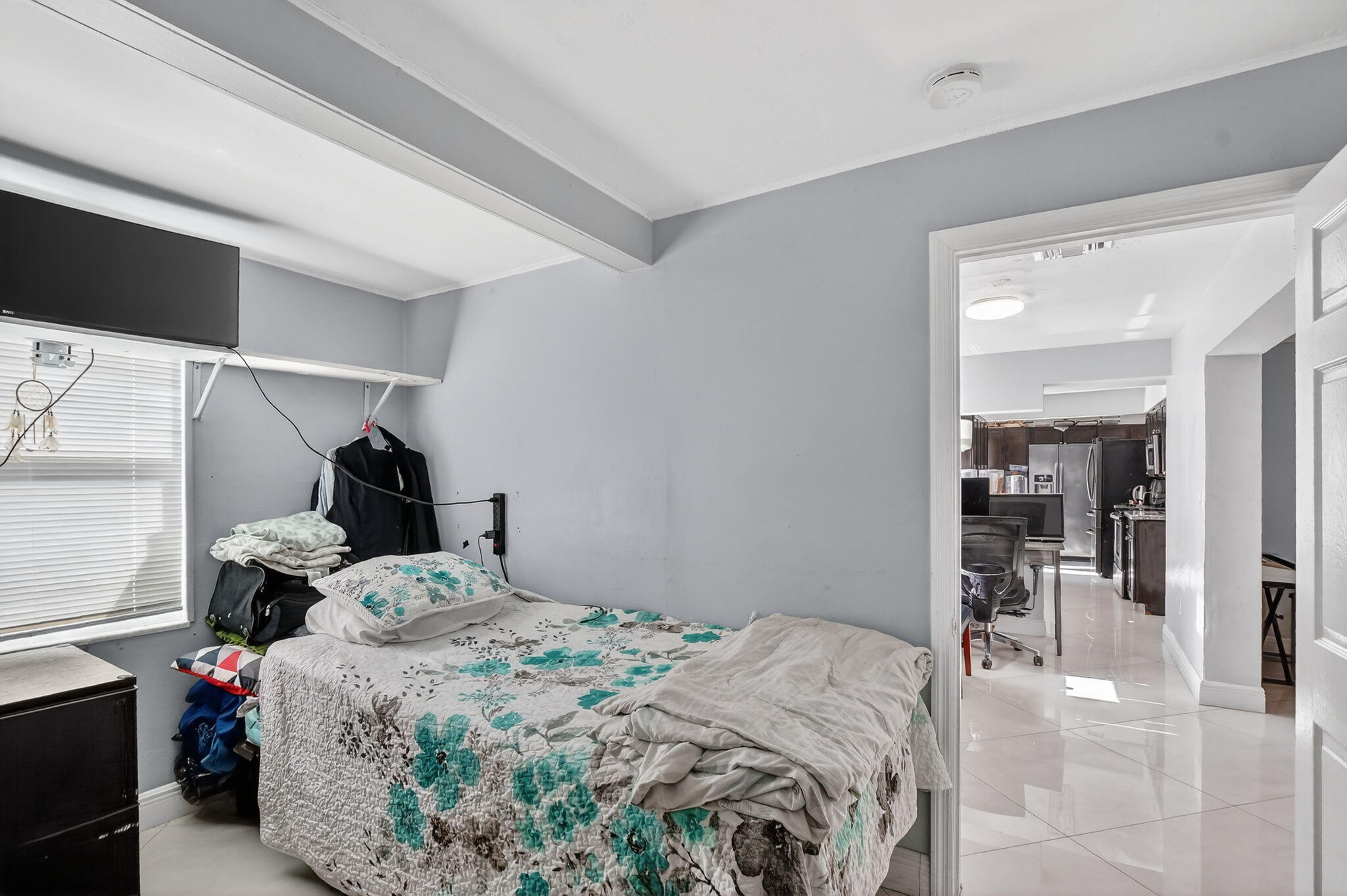 256 Southwest 11th Place Boca Raton, FL 33432 - Photo 24 of 43 a bedroom with a bed and a mirror