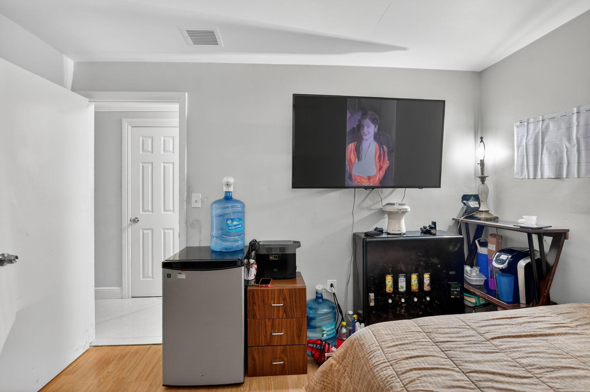 256 Southwest 11th Place Boca Raton, FL 33432 - Photo 26 of 43 a bedroom with a bed and a lamp on dresser