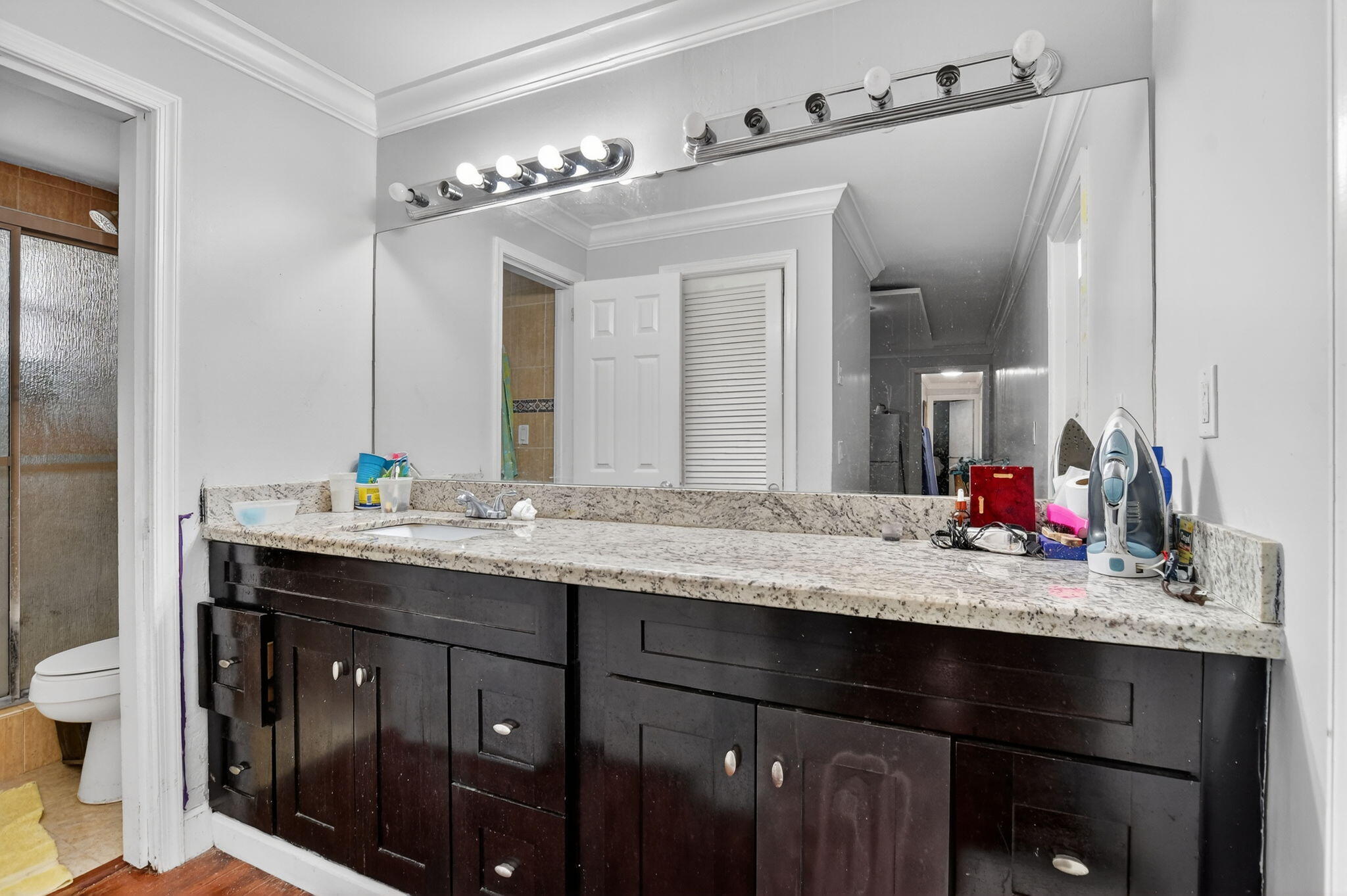 256 Southwest 11th Place Boca Raton, FL 33432 - Photo 30 of 43 a bathroom with a granite countertop sink and a mirror