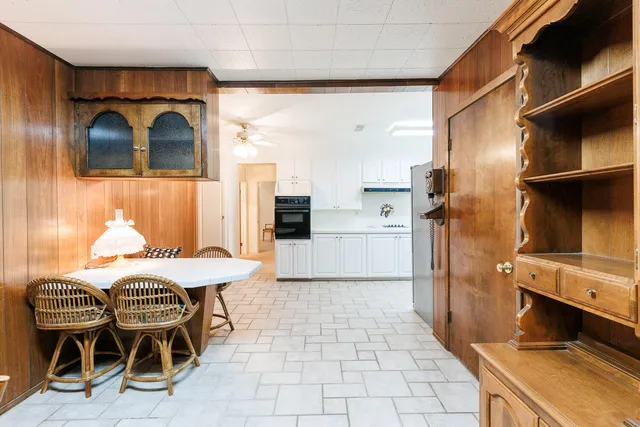 a kitchen with white cabinets and white appliances
