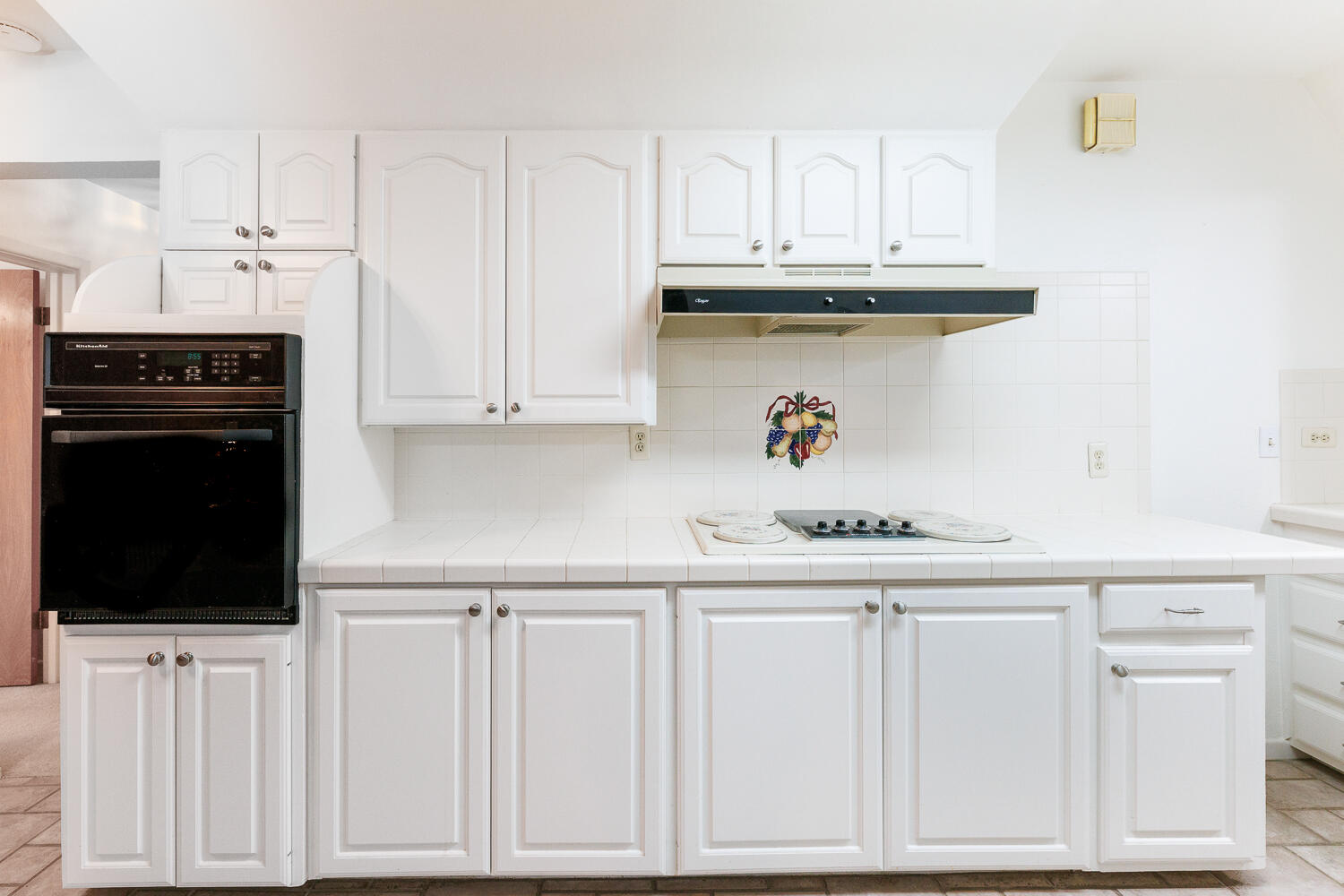 850 South 10th Street Slaton, TX 79364 - Photo 16 of 57 a kitchen with white cabinets and appliances