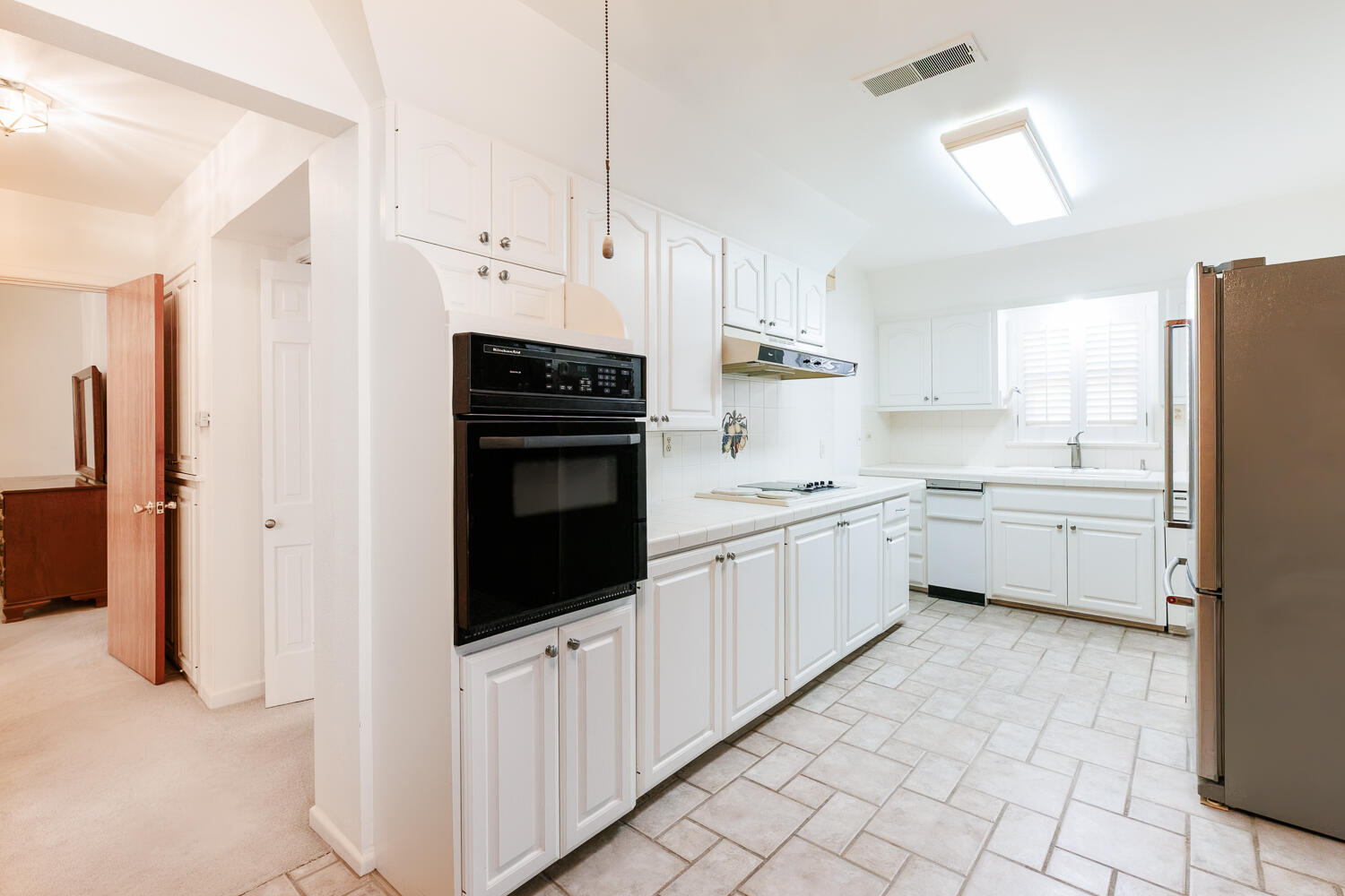 850 South 10th Street Slaton, TX 79364 - Photo 17 of 57 a kitchen with white cabinets and white appliances