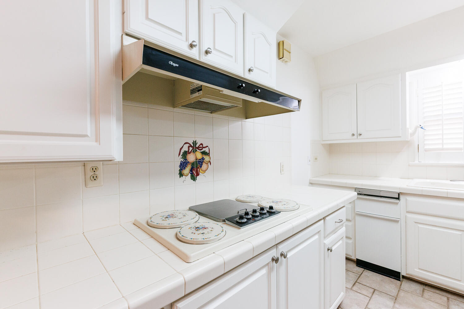 850 South 10th Street Slaton, TX 79364 - Photo 18 of 57 a kitchen with white cabinets and appliances