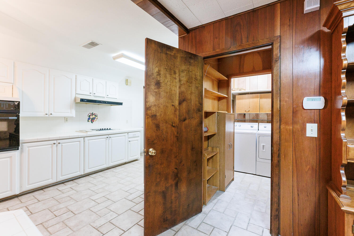 850 South 10th Street Slaton, TX 79364 - Photo 22 of 57 a kitchen with a refrigerator and white cabinets