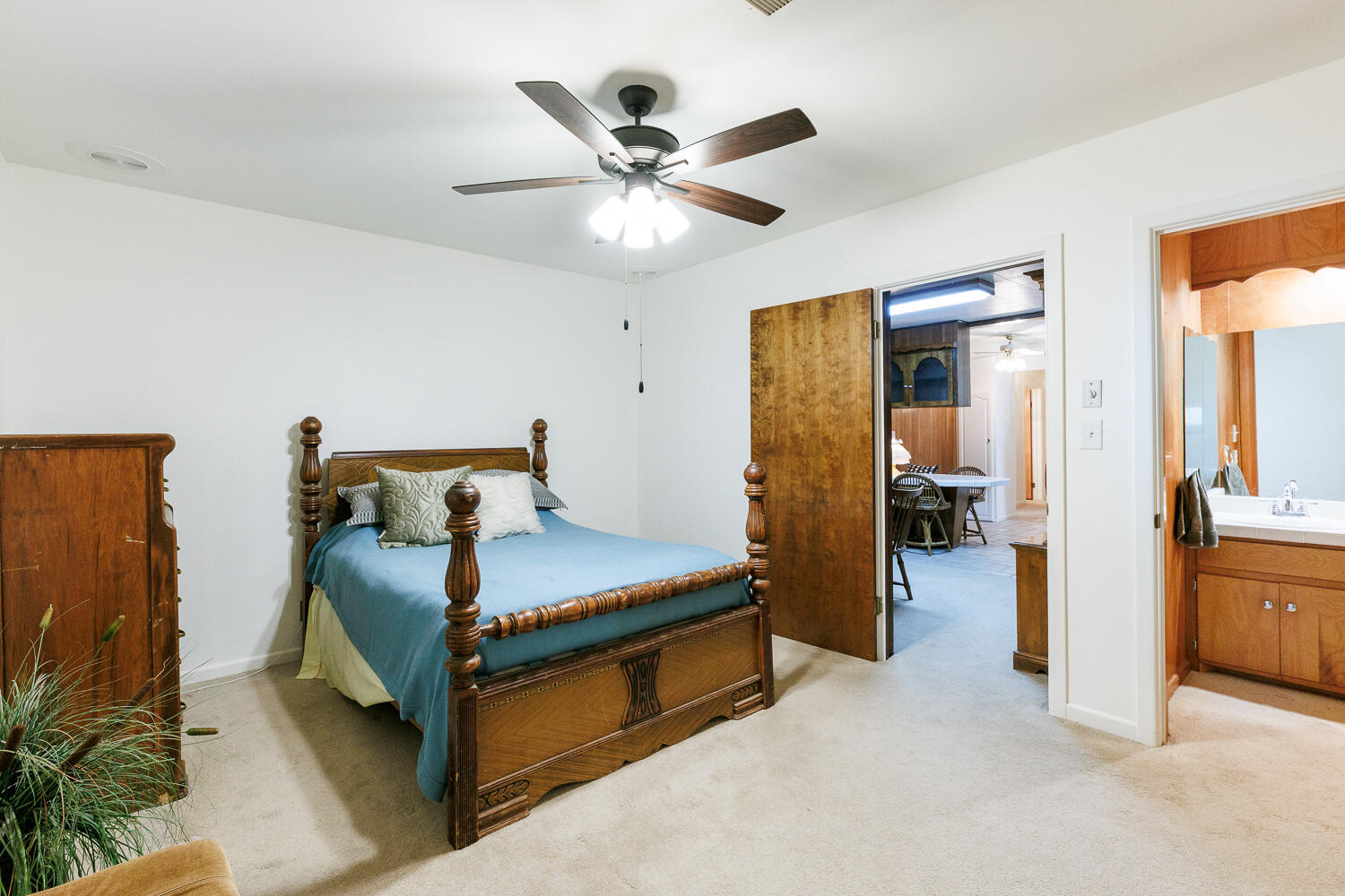 850 South 10th Street Slaton, TX 79364 - Photo 25 of 57 a bedroom with a bed and a chandelier