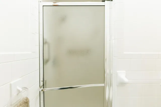 a bathroom with a sink a mirror and a shower