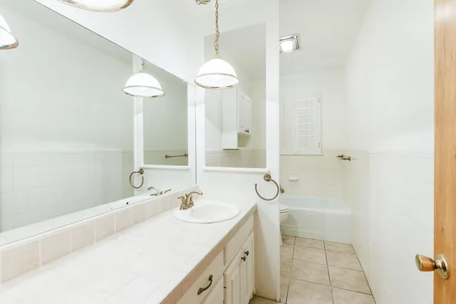 a bedroom with a bed and a dresser in it