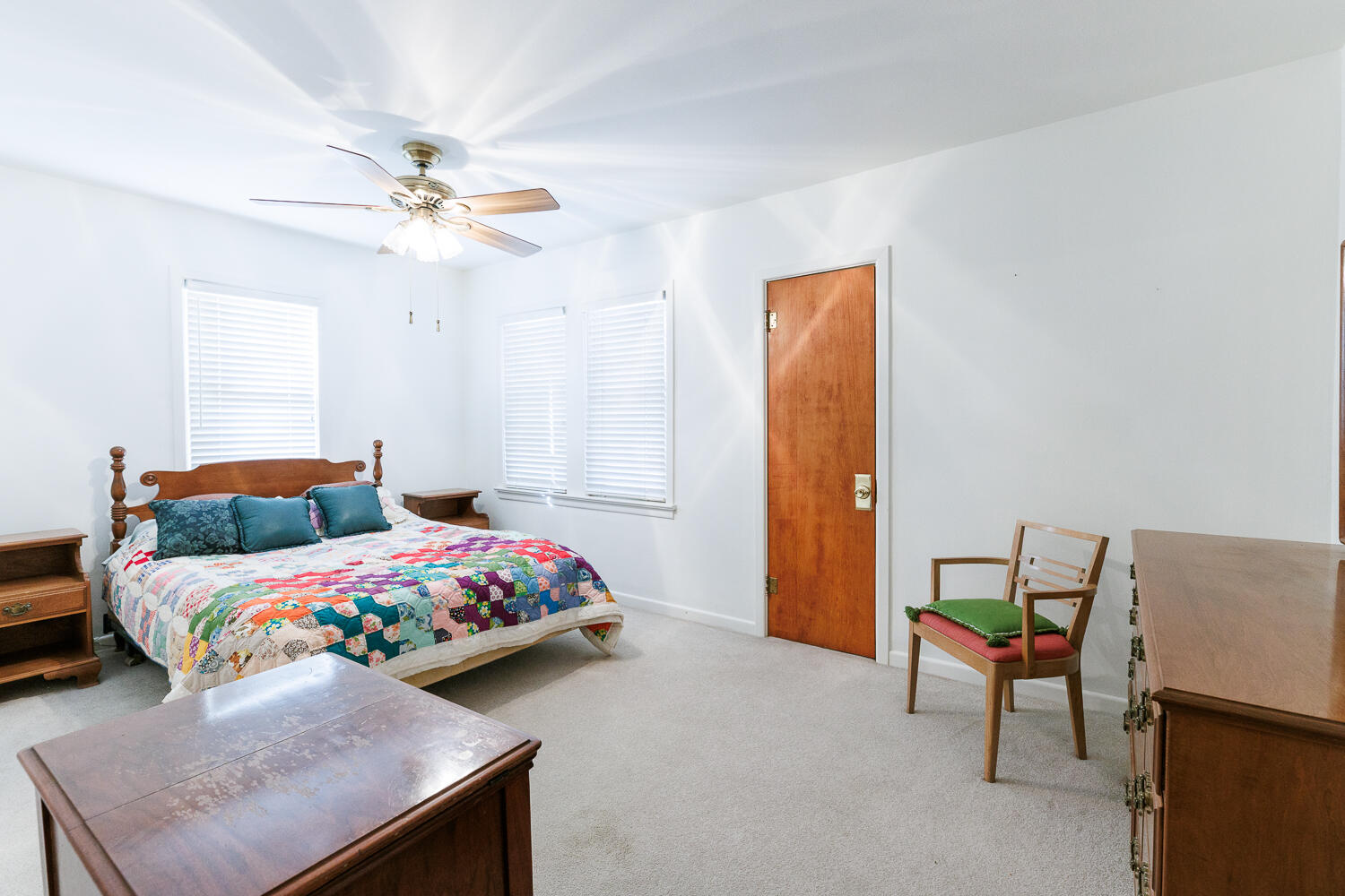 850 South 10th Street Slaton, TX 79364 - Photo 34 of 57 a bedroom with a bed and a chandelier