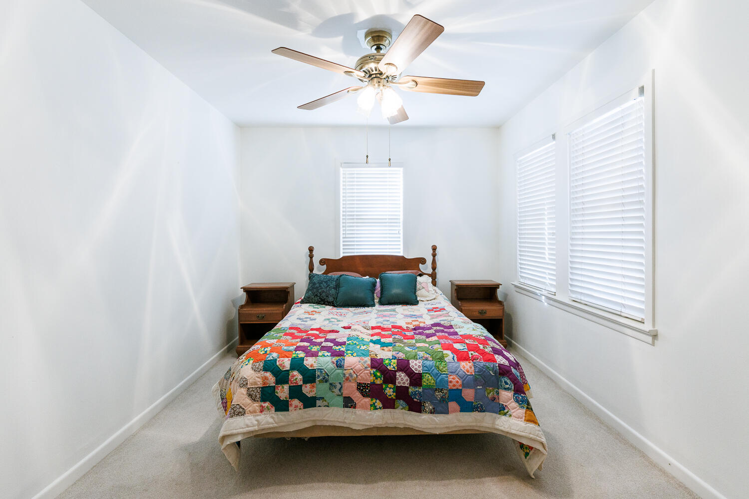 850 South 10th Street Slaton, TX 79364 - Photo 35 of 57 a bedroom with a bed a window and a chandelier