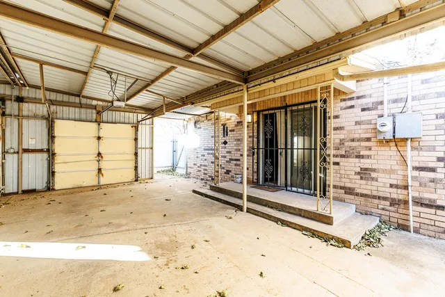 an empty room with a ceiling fan and a window