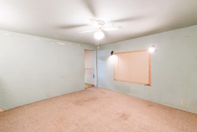 a view of a house with backyard and a tree