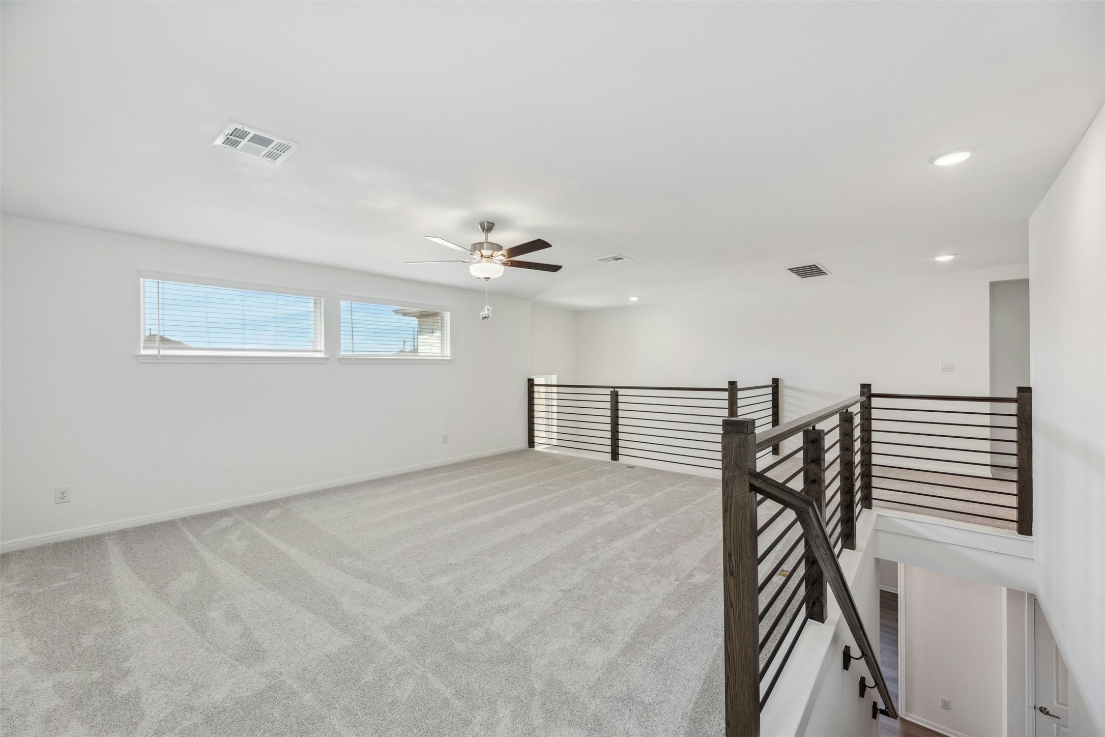 2001 Wynn Road Hutto, TX 78634 - Photo 25 of 39 A spacious upper-level loft area offers versatility and a bright, open feel.
