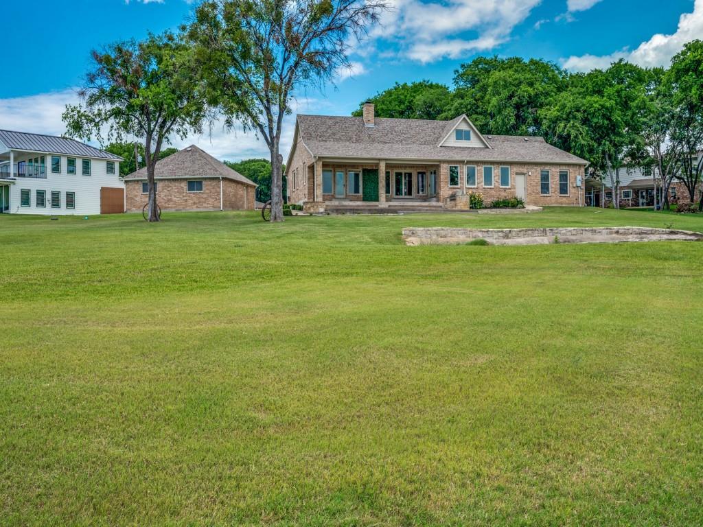 5975 Diamond Spur Frisco, TX 75036 - Photo 35 of 40 a front view of a house with a garden and trees