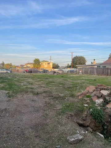 a view of a field with an ocean view