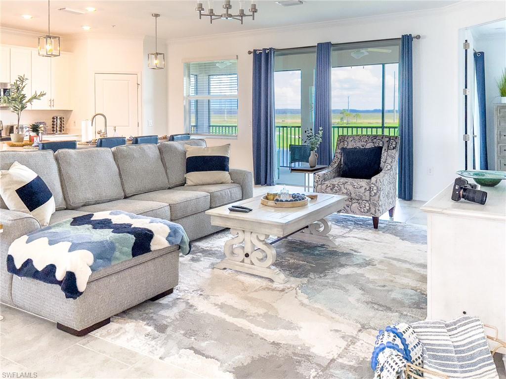 6012 Ellerston Way Avenue, Unit 1121 Immokalee, FL 34142 - Photo 1 of 50 a living room with furniture and a large window