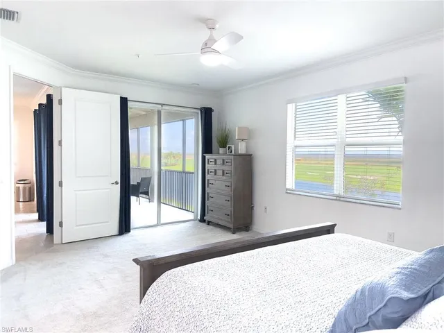 a bedroom with a large bed and a flat tv screen