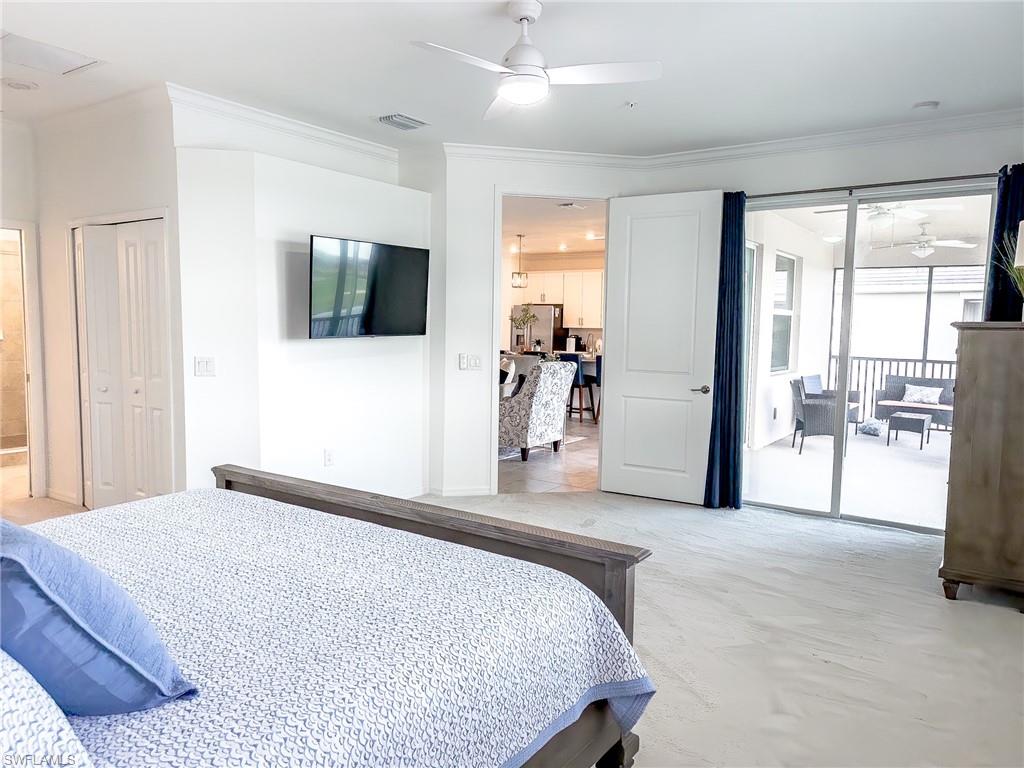 6012 Ellerston Way Avenue, Unit 1121 Immokalee, FL 34142 - Photo 15 of 50 a bedroom with a large bed and a flat tv screen
