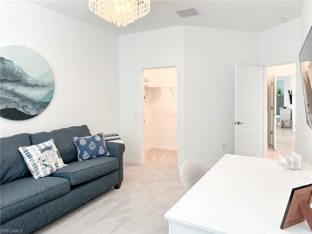 6012 Ellerston Way Avenue, Unit 1121 Immokalee, FL 34142 - Photo 21 of 50 a living room with furniture and a wooden floor