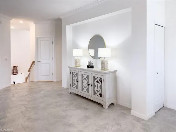 a kitchen with stainless steel appliances granite countertop a table chairs and a refrigerator