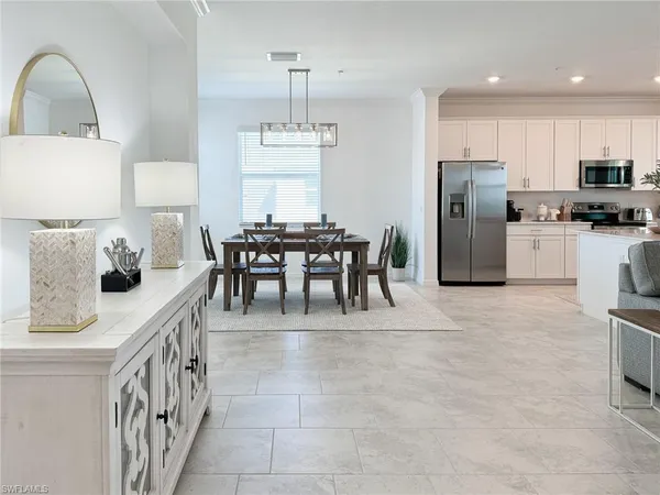a living room with furniture and kitchen view