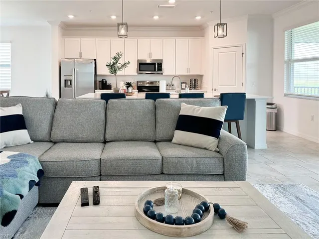 a living room with furniture and flat screen tv